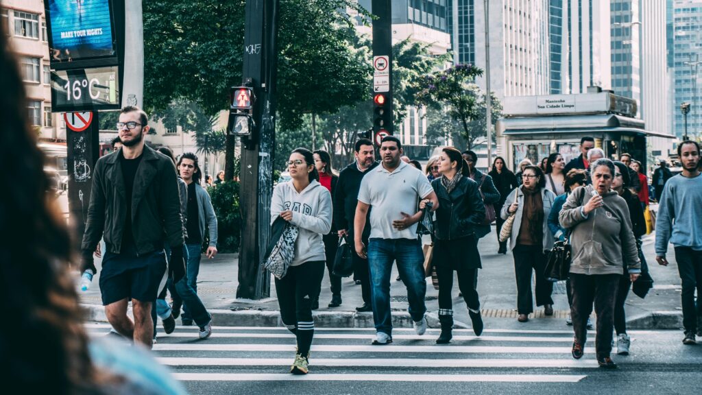 A crowd of local people walking on the pedestrian lane.